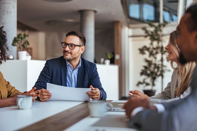 A diverse team engages in a productive business meeting in a modern office. The professional atmosphere is enhanced by teamwork and collaboration, fostering positive discussions and creative planning.