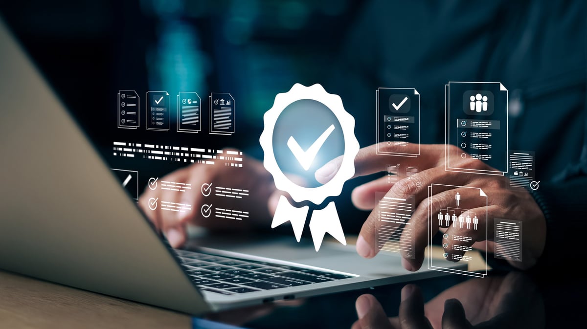 Businessman using laptop with digital checklist and quality badge icon. Concept of quality assurance, compliance audit, certification approval, document management and business standard control